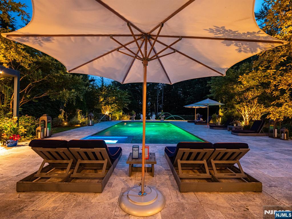 7-11 Stokes Farm Road Old Tappan, NJ 07675 - Photo 37 of 40 a view of a backyard with a patio and a fire pit