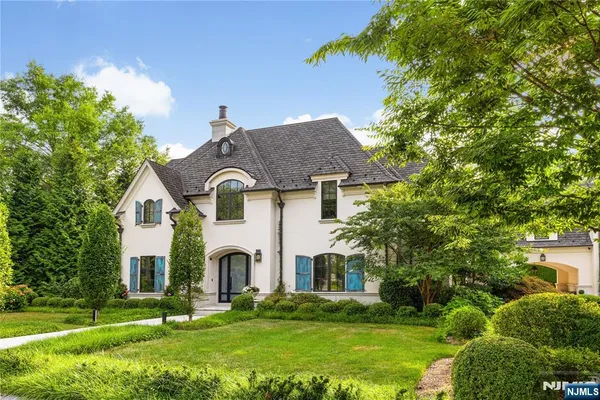 a front view of house with yard and green space