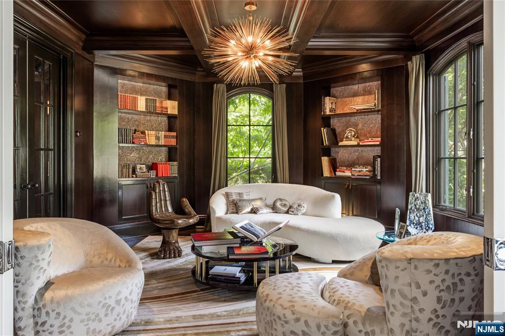 7-11 Stokes Farm Road Old Tappan, NJ 07675 - Photo 9 of 40 a living room with furniture a chandelier and a large window