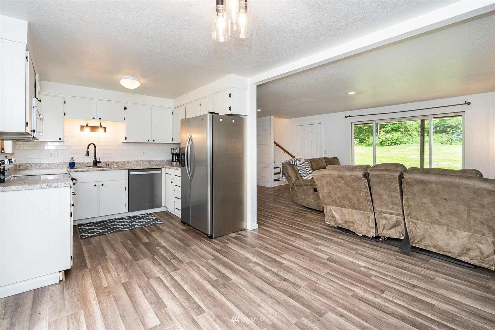 181 Crego Ridge Road Chehalis, WA 98532 - Photo 5 of 33 a kitchen with stainless steel appliances granite countertop a refrigerator a sink dishwasher a stove and white countertops with wooden floor