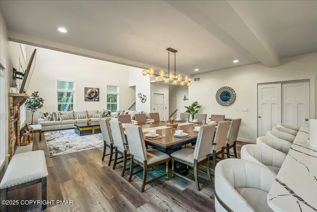 a living room with furniture a flat screen tv and a large window