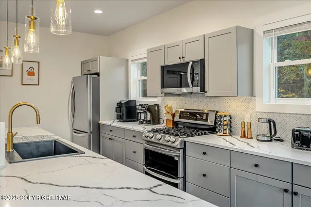 a bedroom with two beds and a ceiling fan