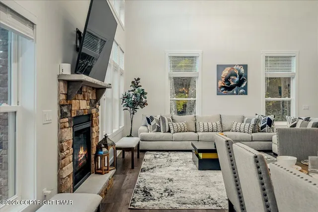 a view of a livingroom with wooden floor and a flat screen tv