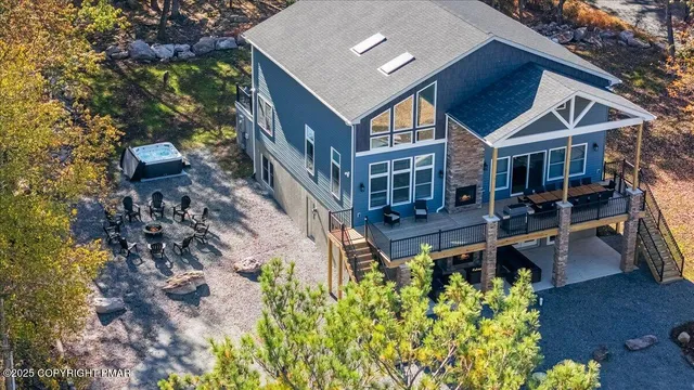 a living room with fireplace furniture and a large window