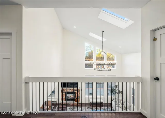 a view of a room with wooden floor and a window