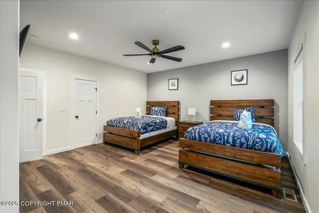 a view of a house with a yard and large trees