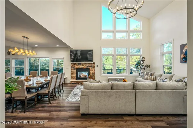 a living room with furniture a flat screen tv and a large window