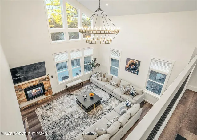 a view of a dining room with furniture and a chandelier