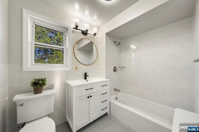 a bathroom with a toilet a sink and a bathtub