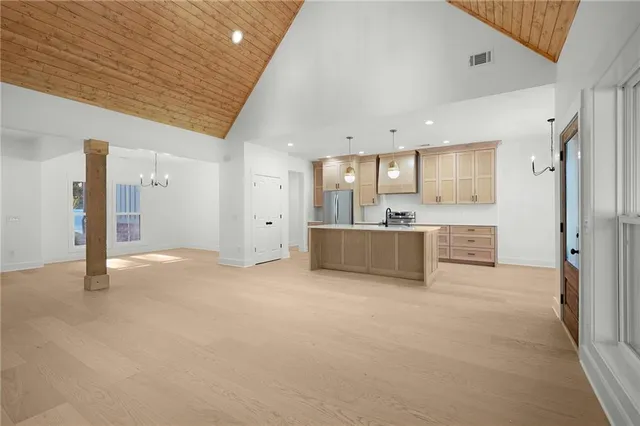 a view of a kitchen with a sink and a refrigerator