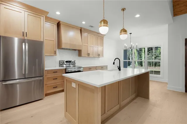 a kitchen with a sink stainless steel appliances and refrigerator