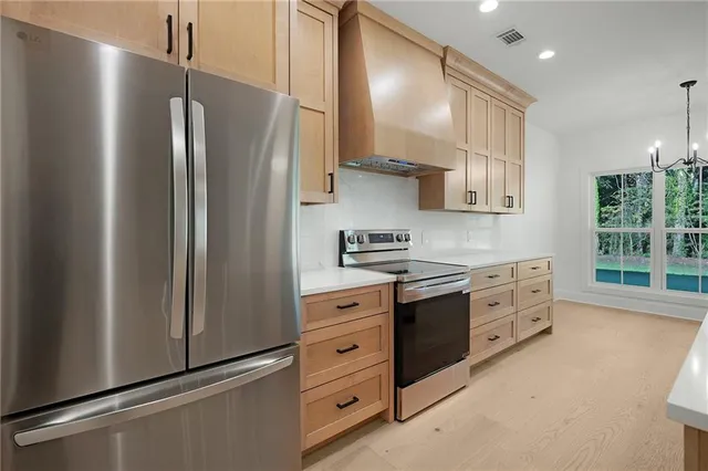 a kitchen with stainless steel appliances a refrigerator sink and cabinets