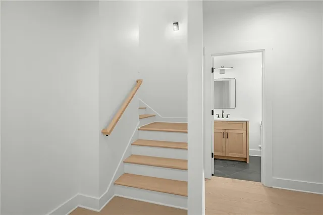 a view of a hallway with a white door and a bathroom