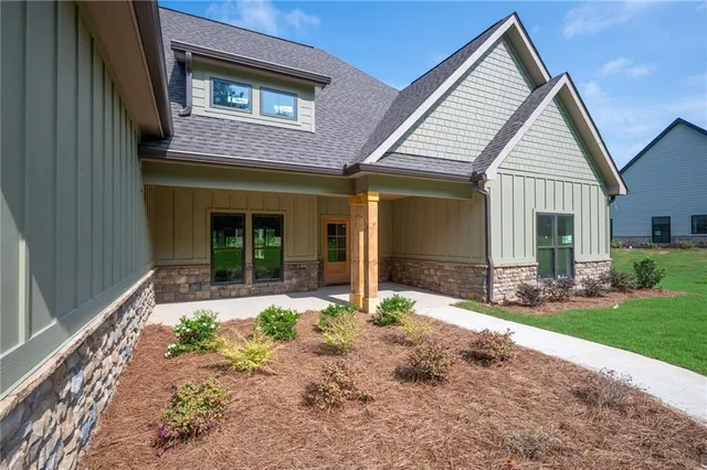 a front view of a house with garden