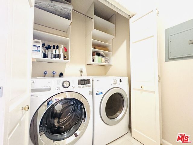 an empty room with windows and fireplace