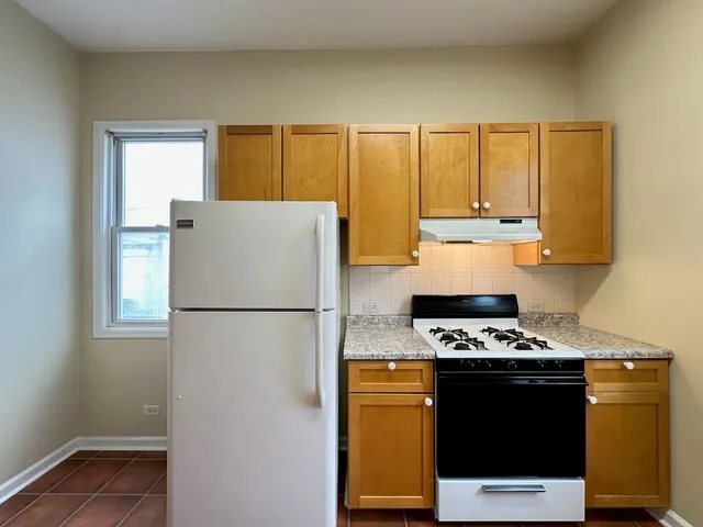 a kitchen with stainless steel appliances a refrigerator a stove a sink and a more cabinets
