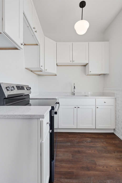 105 High Street, Unit 4P Holyoke, MA 01040 - Photo 4 of 11 a kitchen with cabinets appliances a sink and a stove