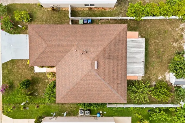 an aerial view of a house with a yard and plants