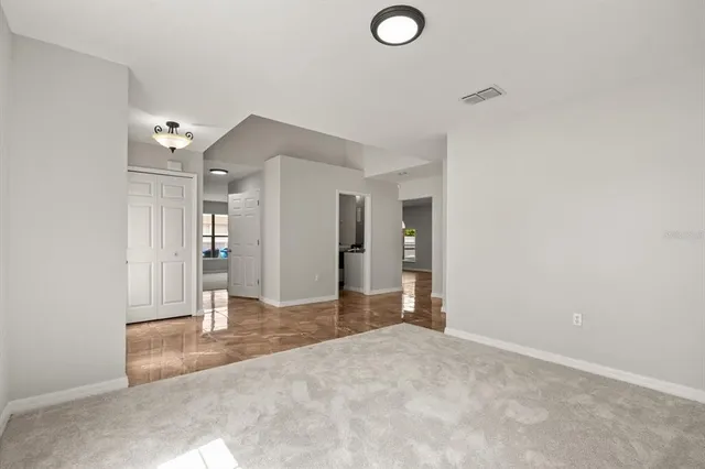 a view of a livingroom with wooden floor and bathroom