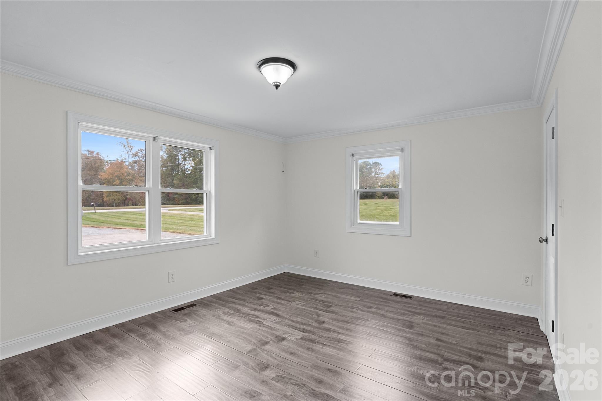1335 Blacksnake Road Stanley, NC 28164 - Photo 13 of 31 a view of an empty room with wooden floor and a window