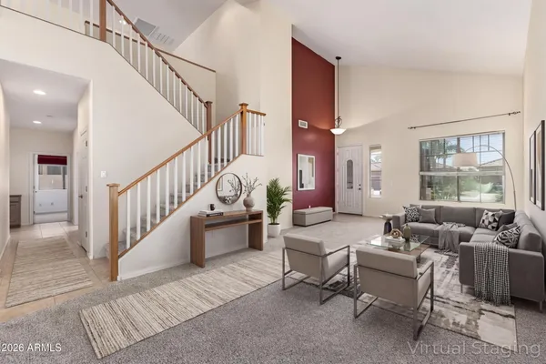 an empty room with windows and ceiling fan