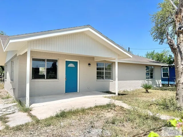 a front view of a house with a yard and seating area