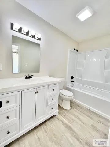 a bathroom with a double vanity sink toilet mirror and bathtub