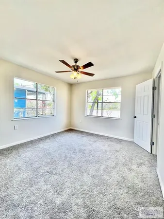 an empty room with windows and closet