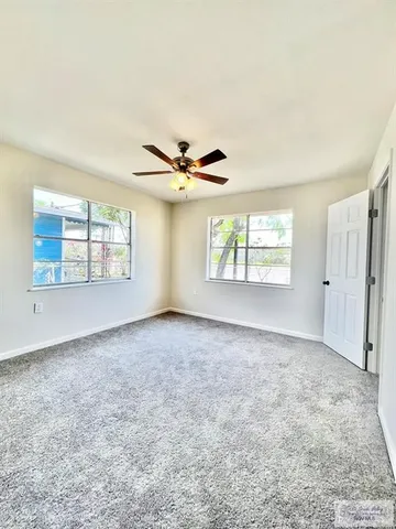 an empty room with windows and closet