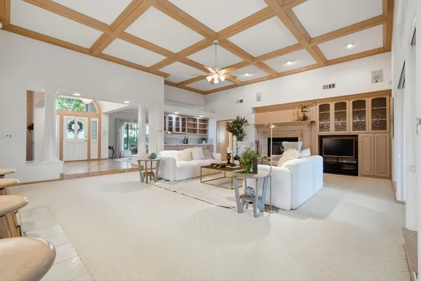 a living room with furniture and a chandelier