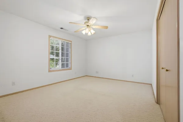 a bed room with a bed and a large window