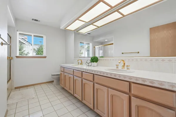 a bathroom with a tub sink and mirror