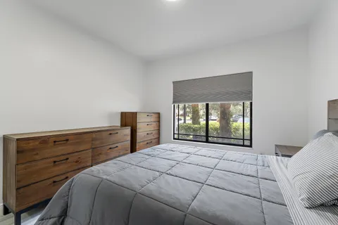 a bedroom with a bed and window