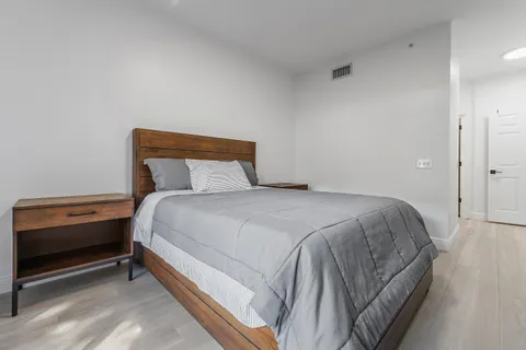 a bedroom with a bed and a window