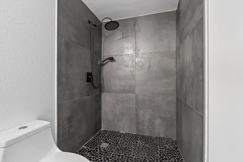 a bathroom with a shower and a toilet