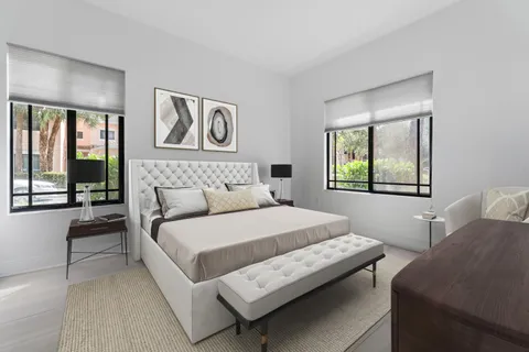 a bedroom with a bed and a large window