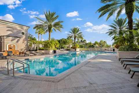 a view of swimming pool with outdoor seating and plants