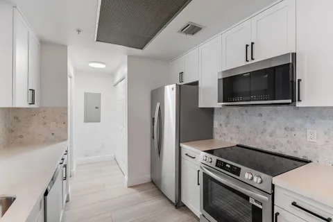 a kitchen with a stove and a microwave