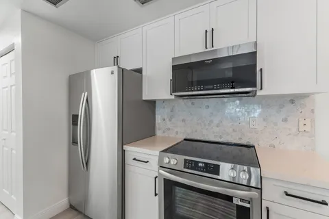 a kitchen with a stove and a microwave