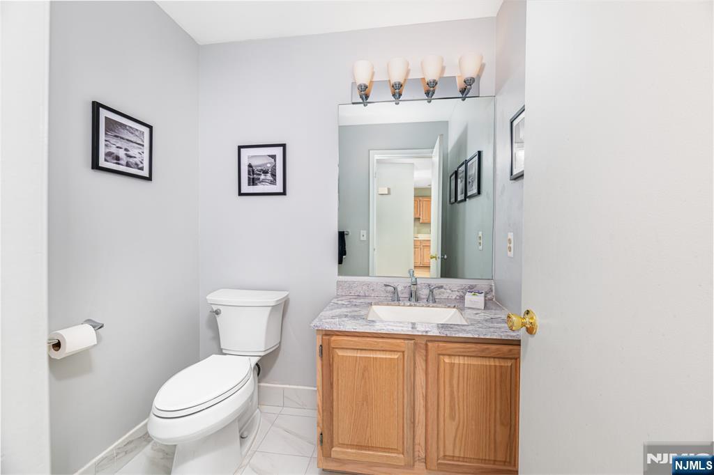 44 Mill Pond Road Little Falls, NJ 07424 - Photo 12 of 37 a bathroom with a granite countertop toilet sink and mirror