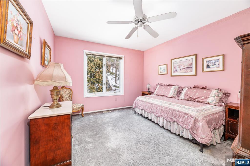 44 Mill Pond Road Little Falls, NJ 07424 - Photo 28 of 37 a spacious bedroom with a bed and a window