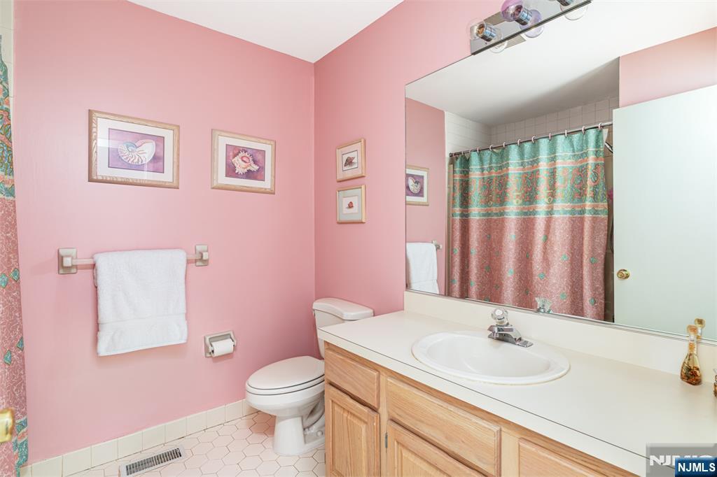 44 Mill Pond Road Little Falls, NJ 07424 - Photo 30 of 37 a bathroom with a granite countertop toilet sink and mirror