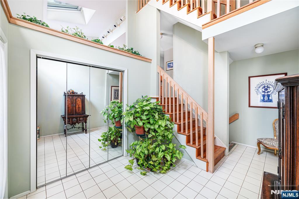 44 Mill Pond Road Little Falls, NJ 07424 - Photo 3 of 37 a hallway with dining room and stairs