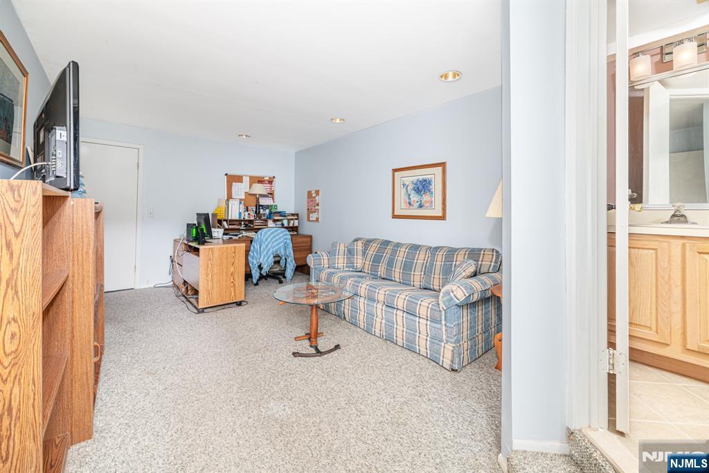 44 Mill Pond Road Little Falls, NJ 07424 - Photo 32 of 37 a living room with furniture and a flat screen tv