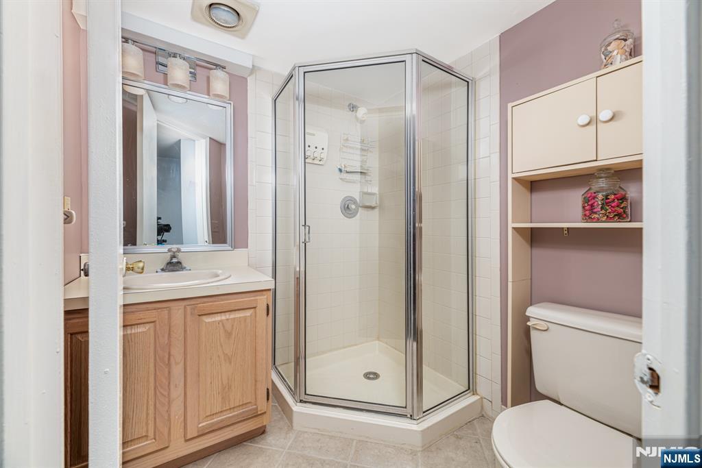 44 Mill Pond Road Little Falls, NJ 07424 - Photo 33 of 37 a bathroom with a granite countertop sink toilet and shower