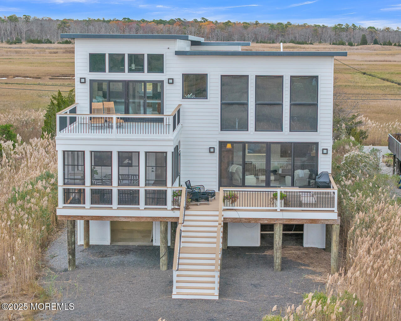 637 Cedar Run Dock Road West Creek, NJ 08092 - Photo 37 of 51 a balcony with a table and chairs