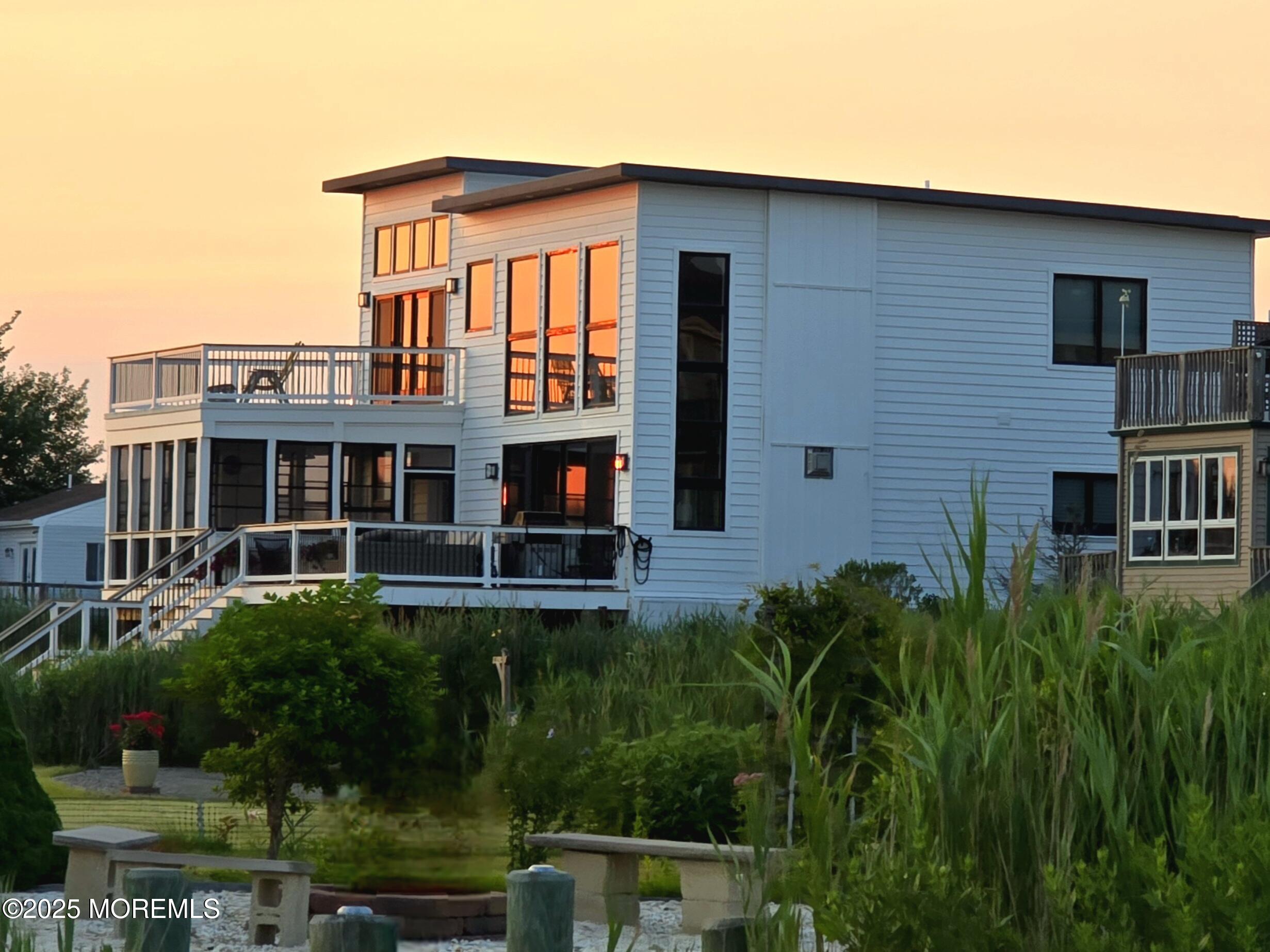 637 Cedar Run Dock Road West Creek, NJ 08092 - Photo 51 of 51 a front view of a house with plants and garden