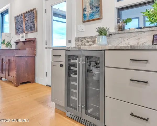 a kitchen with granite countertop a table chairs stainless steel appliances and cabinets