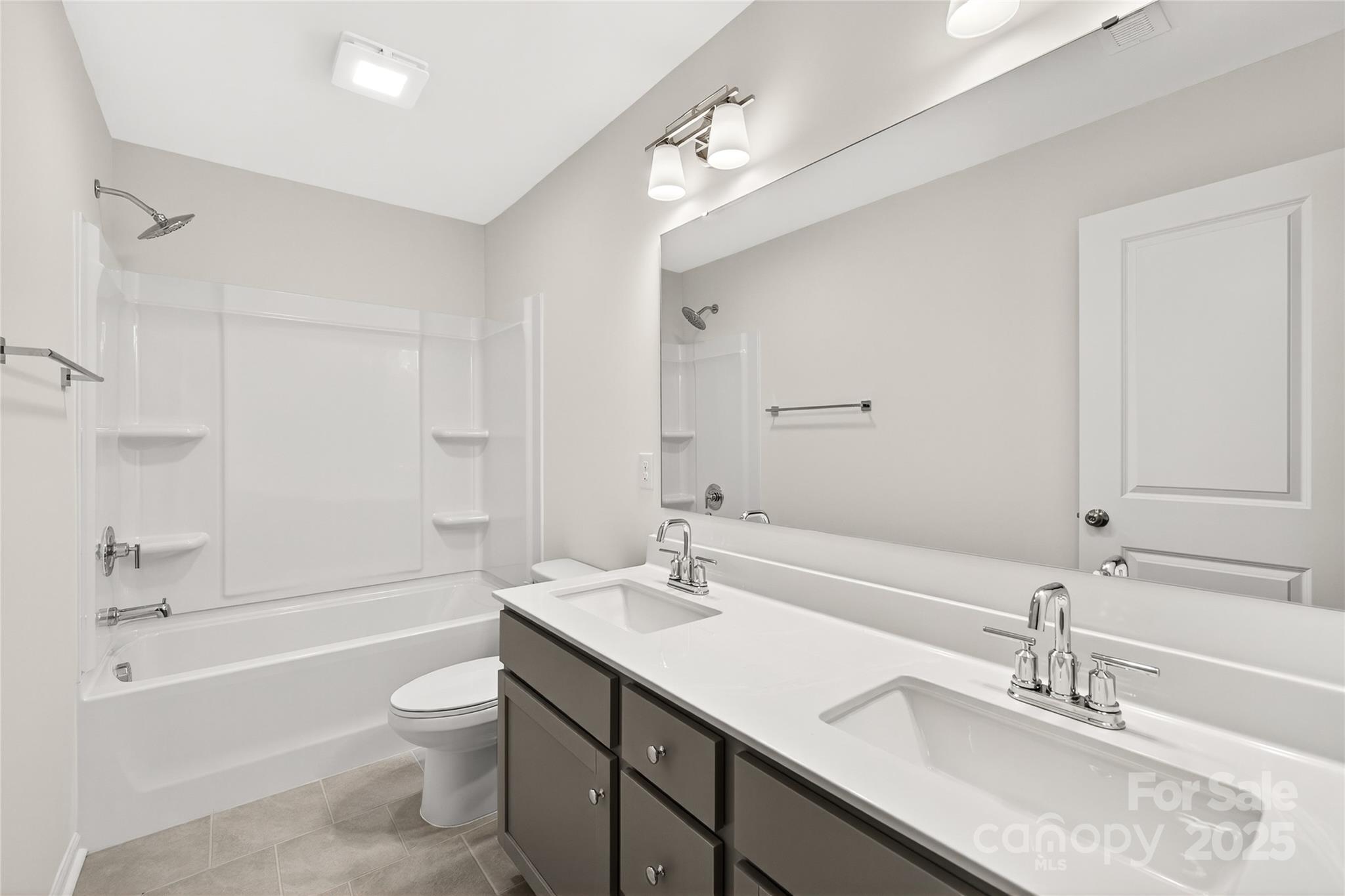 10423 Lakeshore Drive, Unit 71 Lancaster, SC 29720 - Photo 25 of 31 a bathroom with a granite countertop sink a toilet a vanity and shower