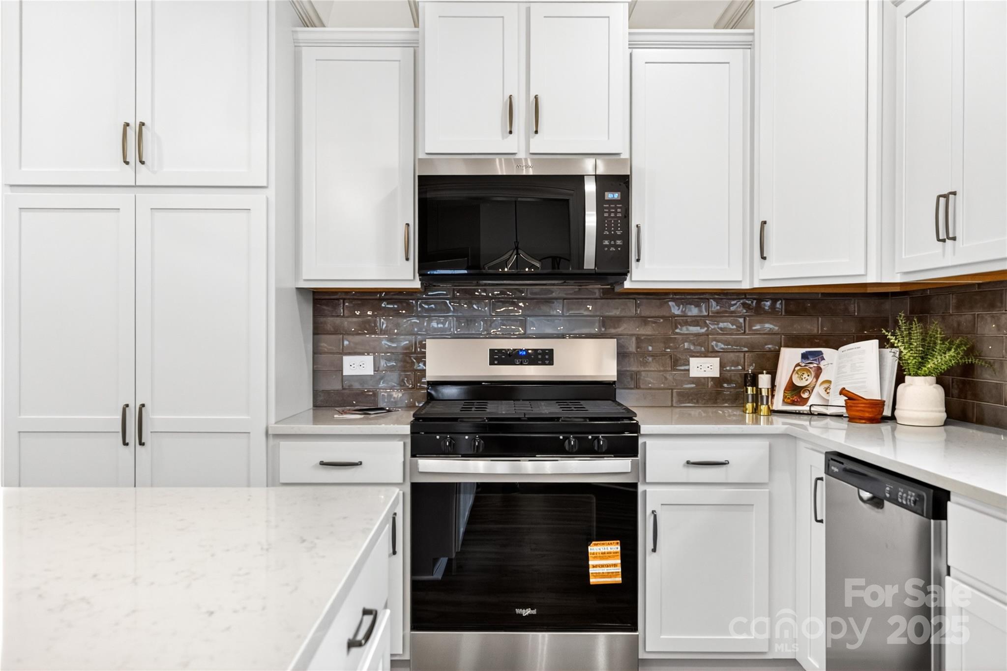 10423 Lakeshore Drive, Unit 71 Lancaster, SC 29720 - Photo 9 of 31 a kitchen with stainless steel appliances granite countertop a stove a sink and a microwave